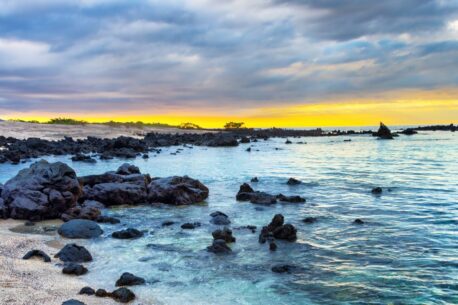 Sunset over a rocky beach on Isabela Island Galapagos