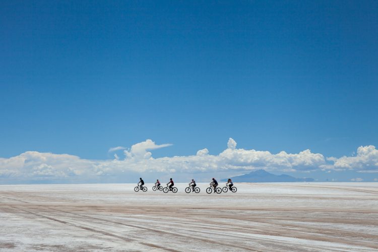 cyclists group riding the salar de Uyuni